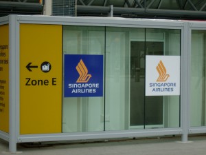 view of a bomb blast proof glazed screen with wayfinding signage on.