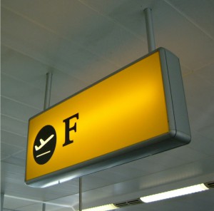 view of an illuminated airport sign for wayfinding within the airport.