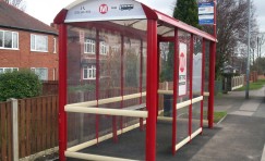 Metro bus shelter with public seating inside.