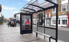 Digital 6 sheet advertising display by a bus shelter.