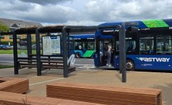 A bus pulling up to the bespoke SuperHub shelter designed and installed by Trueform at Manor Royal BID.