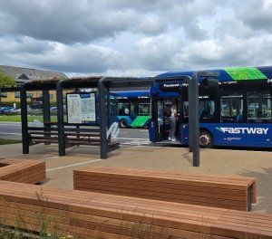 A bus pulling up to the bespoke SuperHub shelter designed and installed by Trueform at Manor Royal BID.